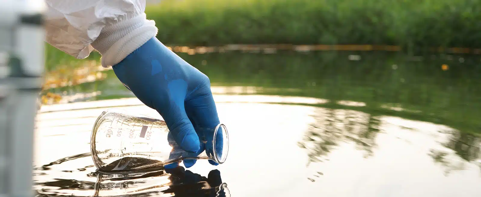 Environment engineer Collect samples of wastewater from industrial canals in test tube, Close up hand with glove Collect samples of wastewater from industrial canals in test tube. mobile water laboratory check